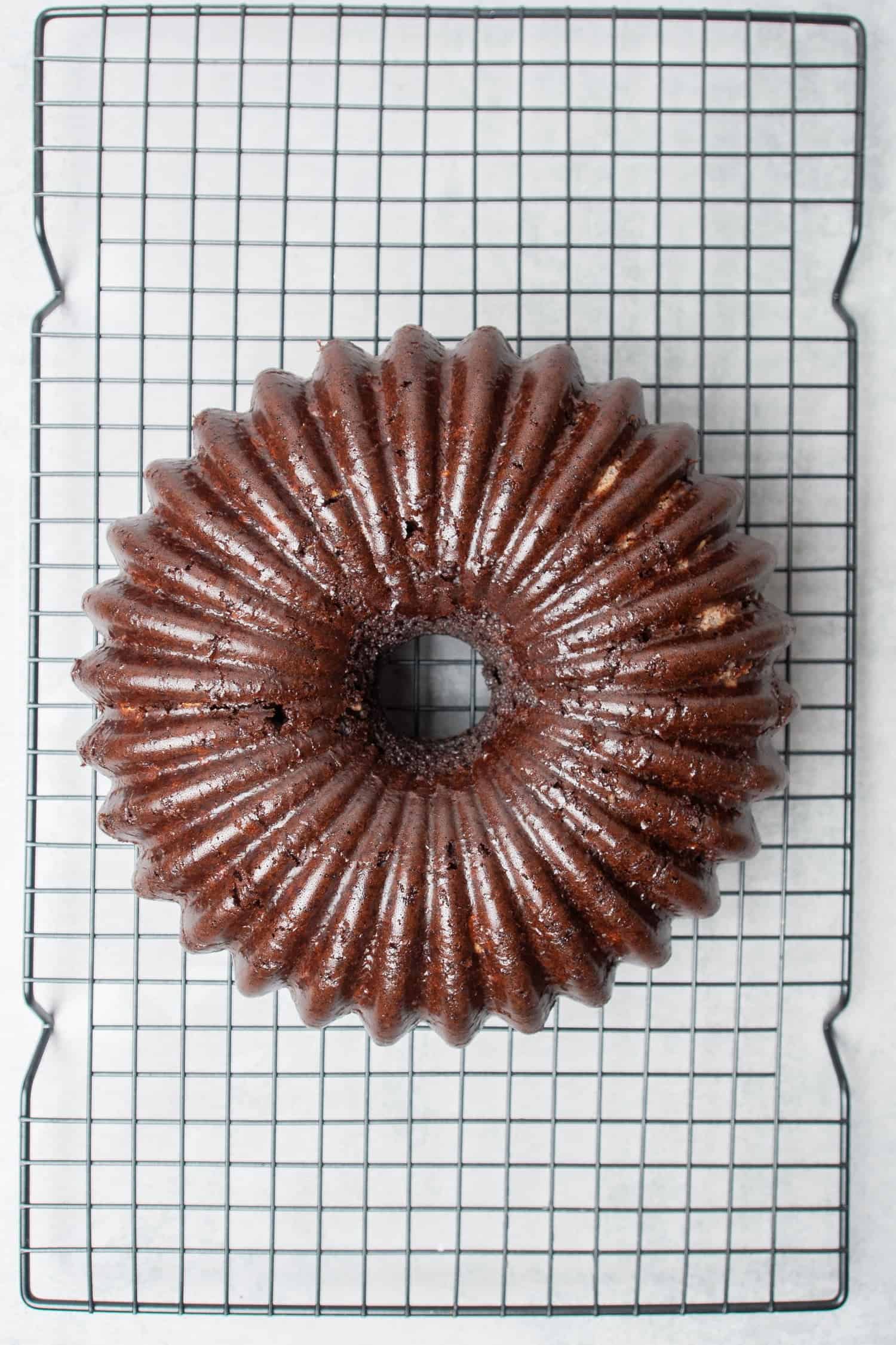Coconut chocolate bundt cake on a cooling rack.