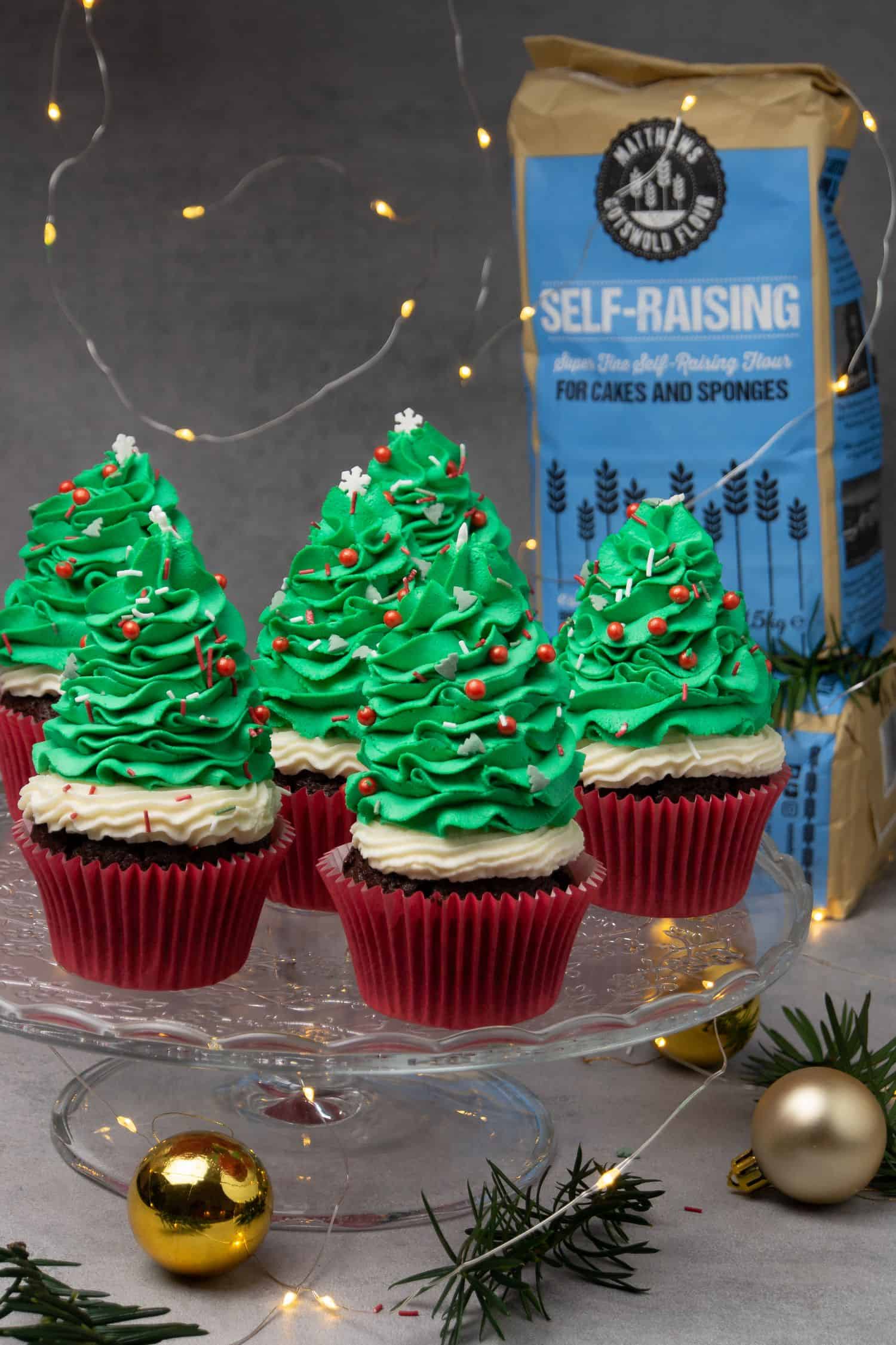 Christmas tree cupcakes on a cake stand.