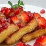 French toast with strawberries on a plate.
