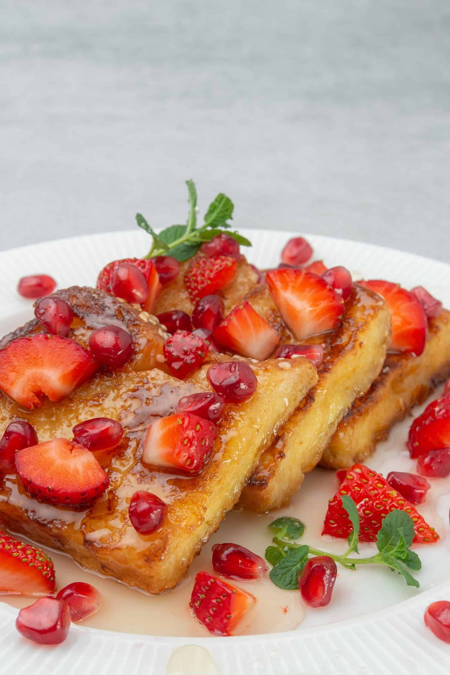 French toast with strawberries on a plate.
