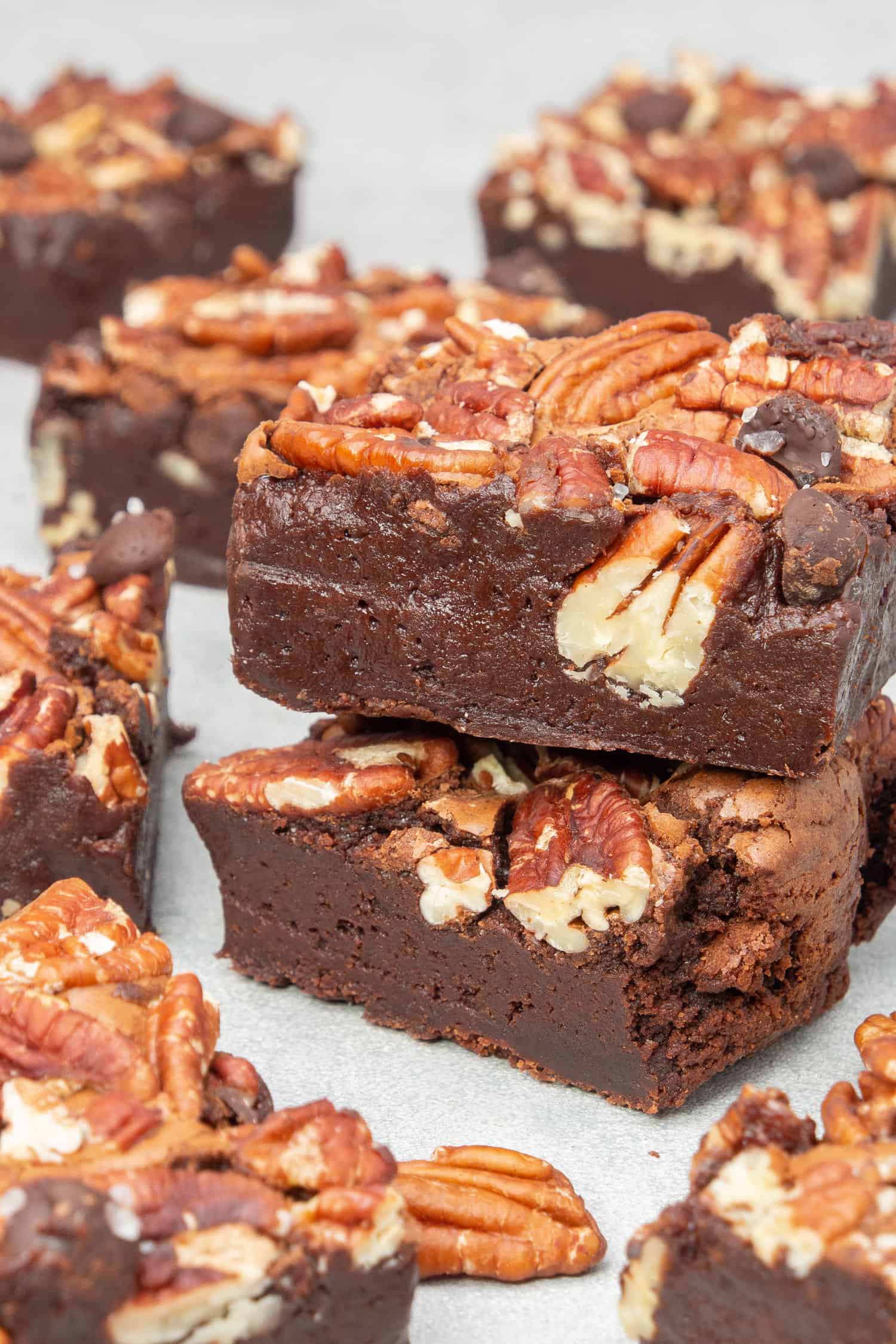 2 Pecan brownies on each others, and surrounded with other brownies.
