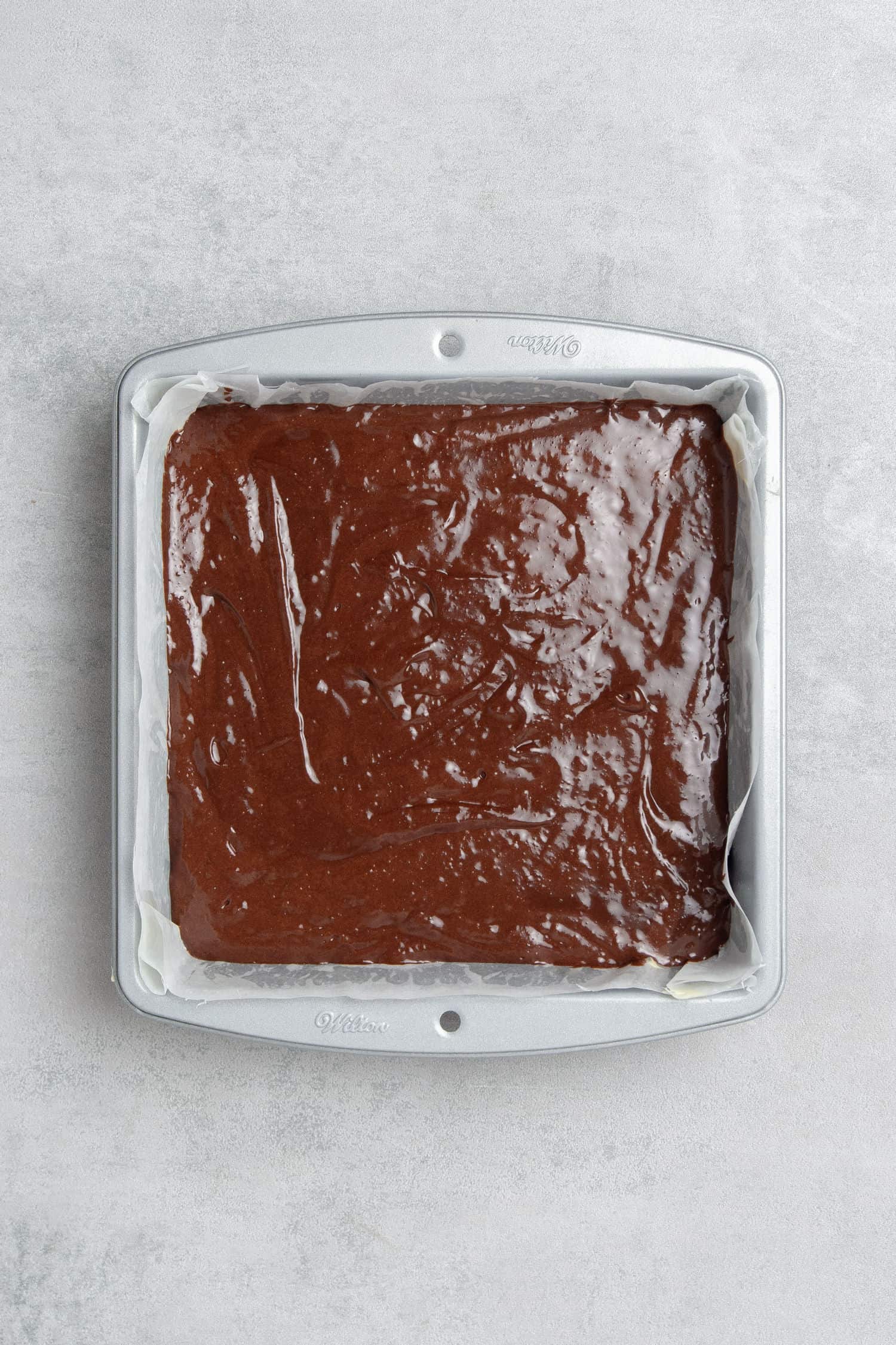Coffee brownie in a baking tin before baking.