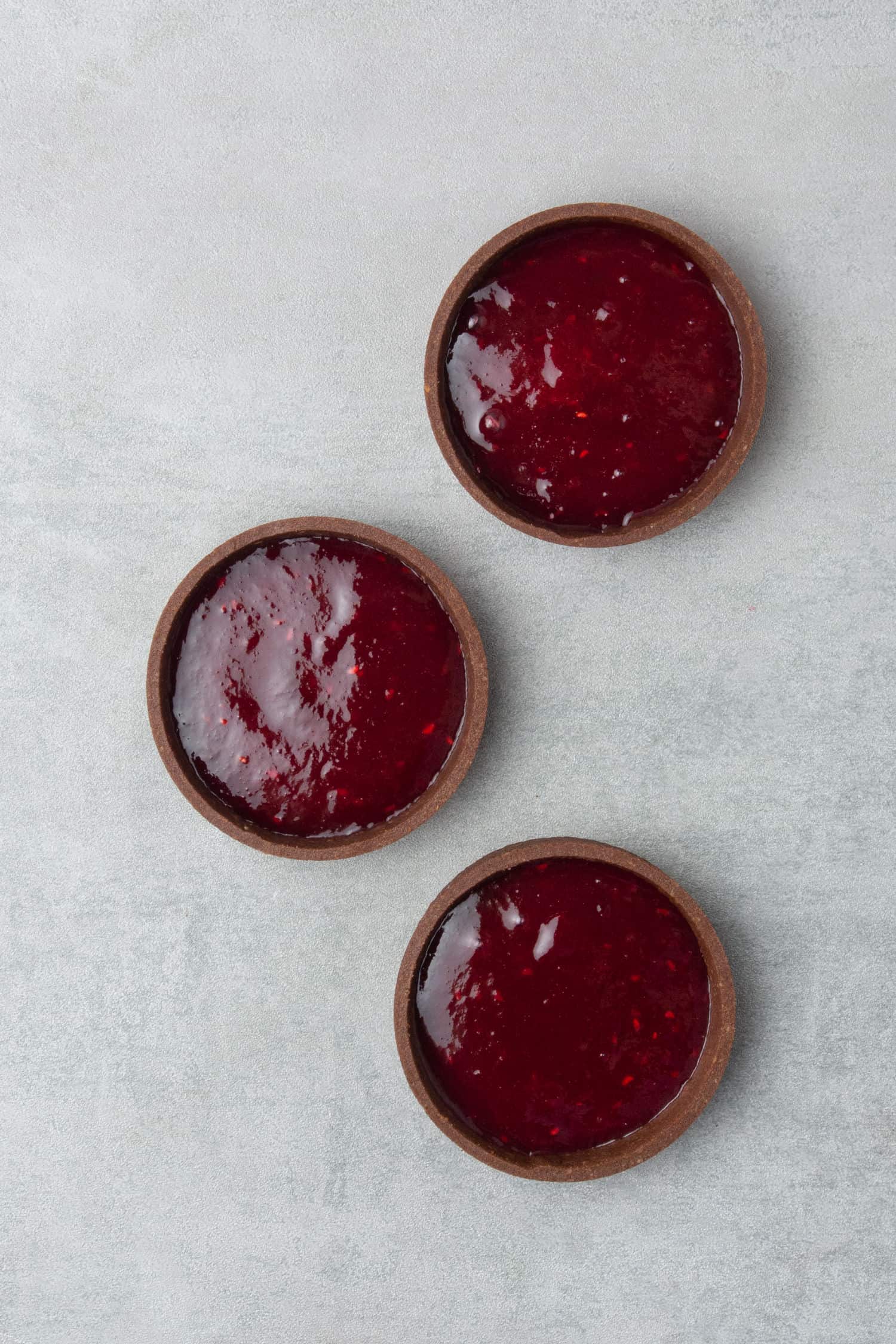 3 pcs of Chocolate tarts filled with raspberry coulis. 