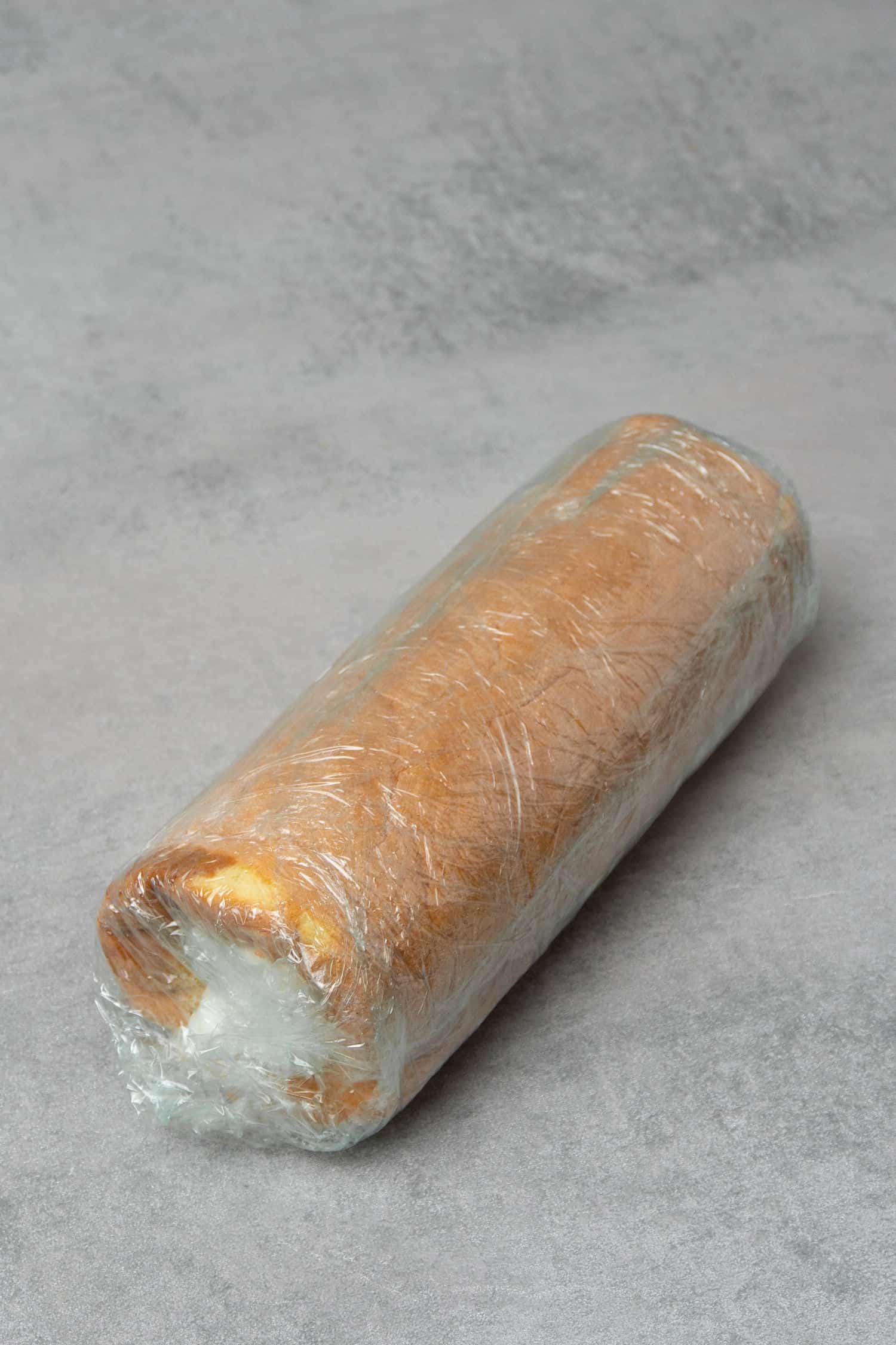 Tiramisu cake roll in a plastic foil.