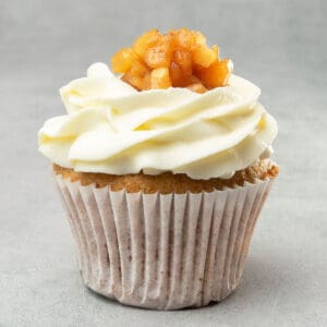 Apple pie cupcake on a grey surface.