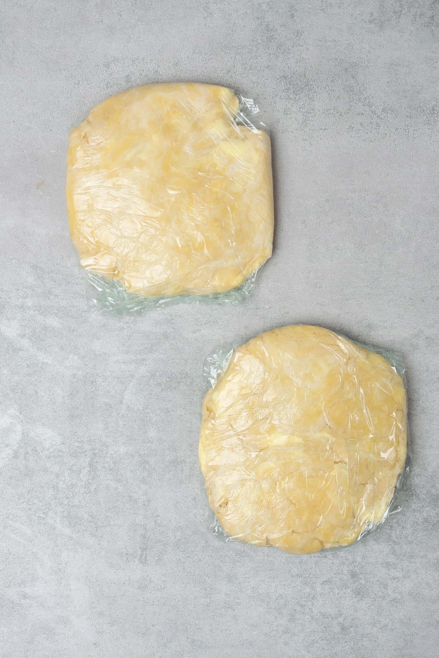 2 pcs of pie dough in plastic foil on a table