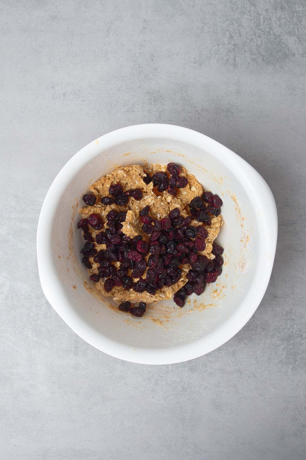 cookie mix in a bowl with dried cranberries on top