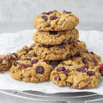 Oatmeal craisin cookies on top of each other on a cooling rack