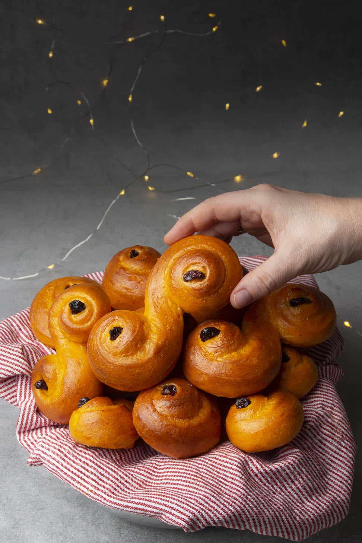 Batch of Lussekatters on a cake stand 