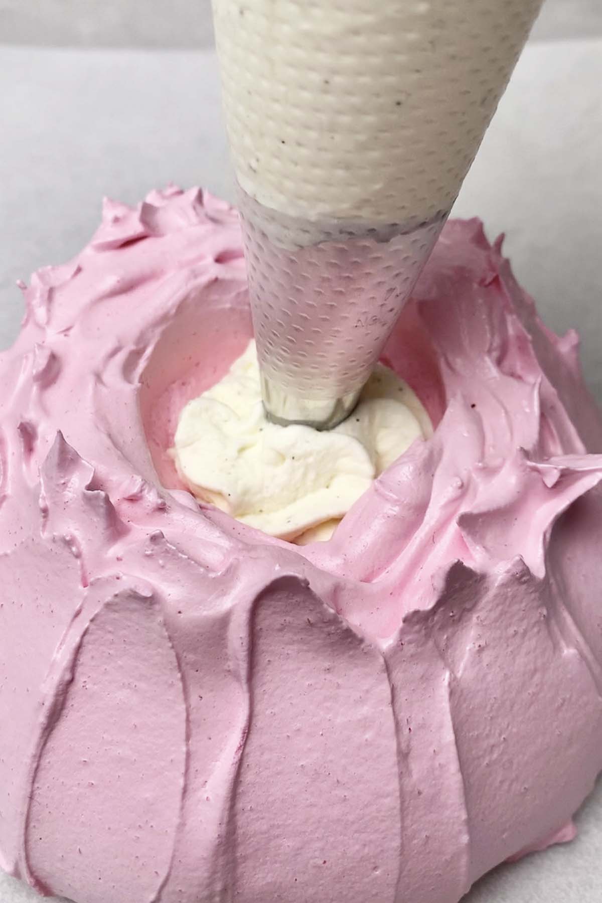 filling the mini pavlova nest with homemade whipped cream