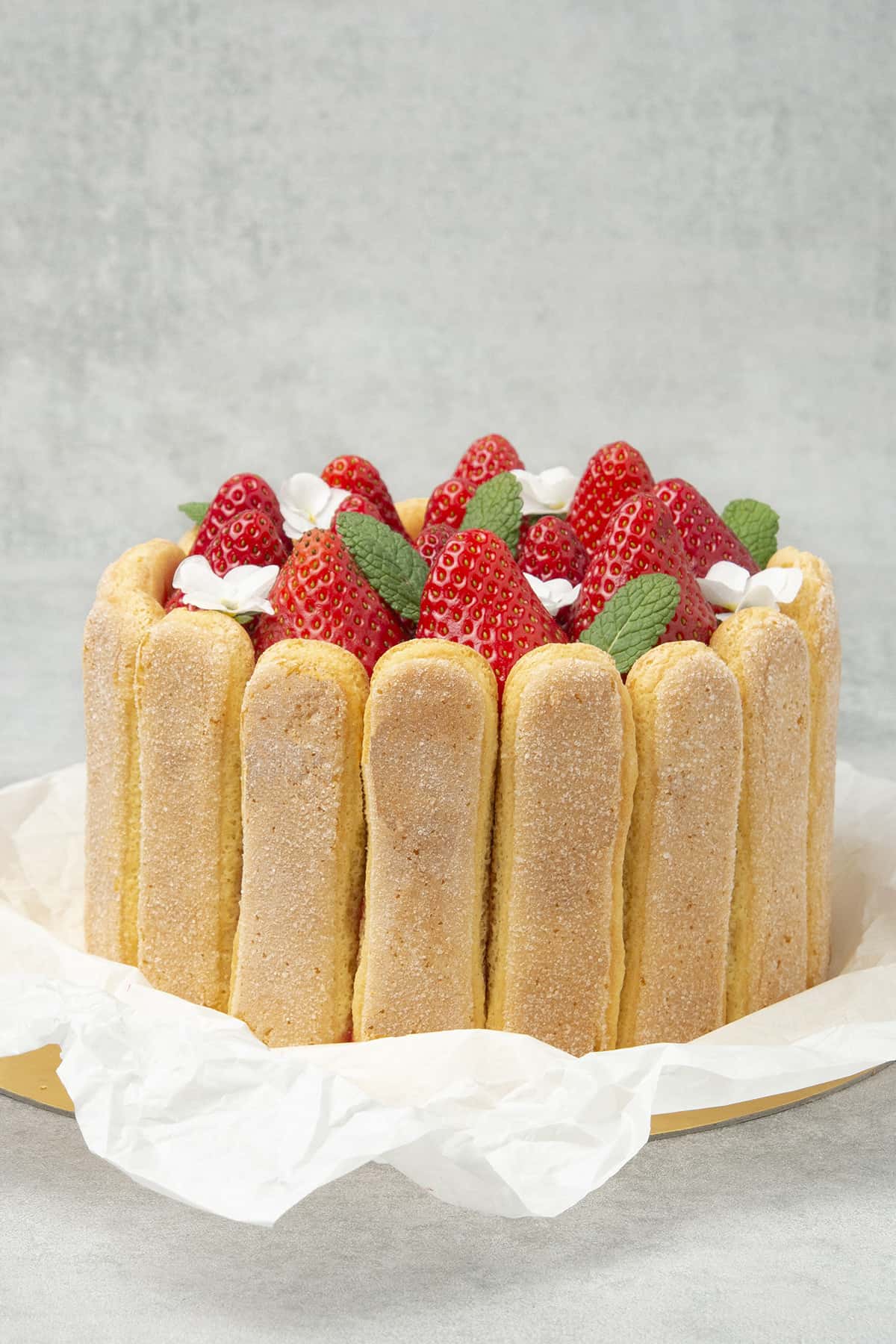 Strawberry charlotte cake on a paper tray