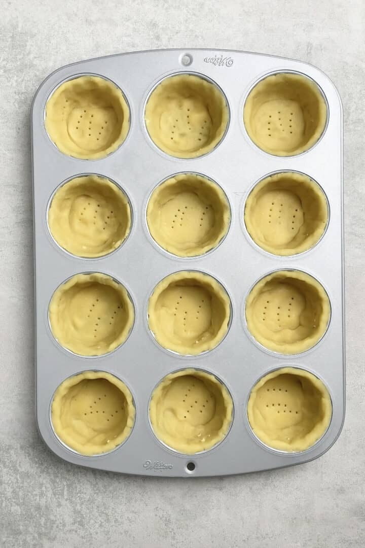 Pastry  dough arrange in a  muffin tin before baking.