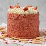 Strawberry crunch cake decorated with fresh strawberries .