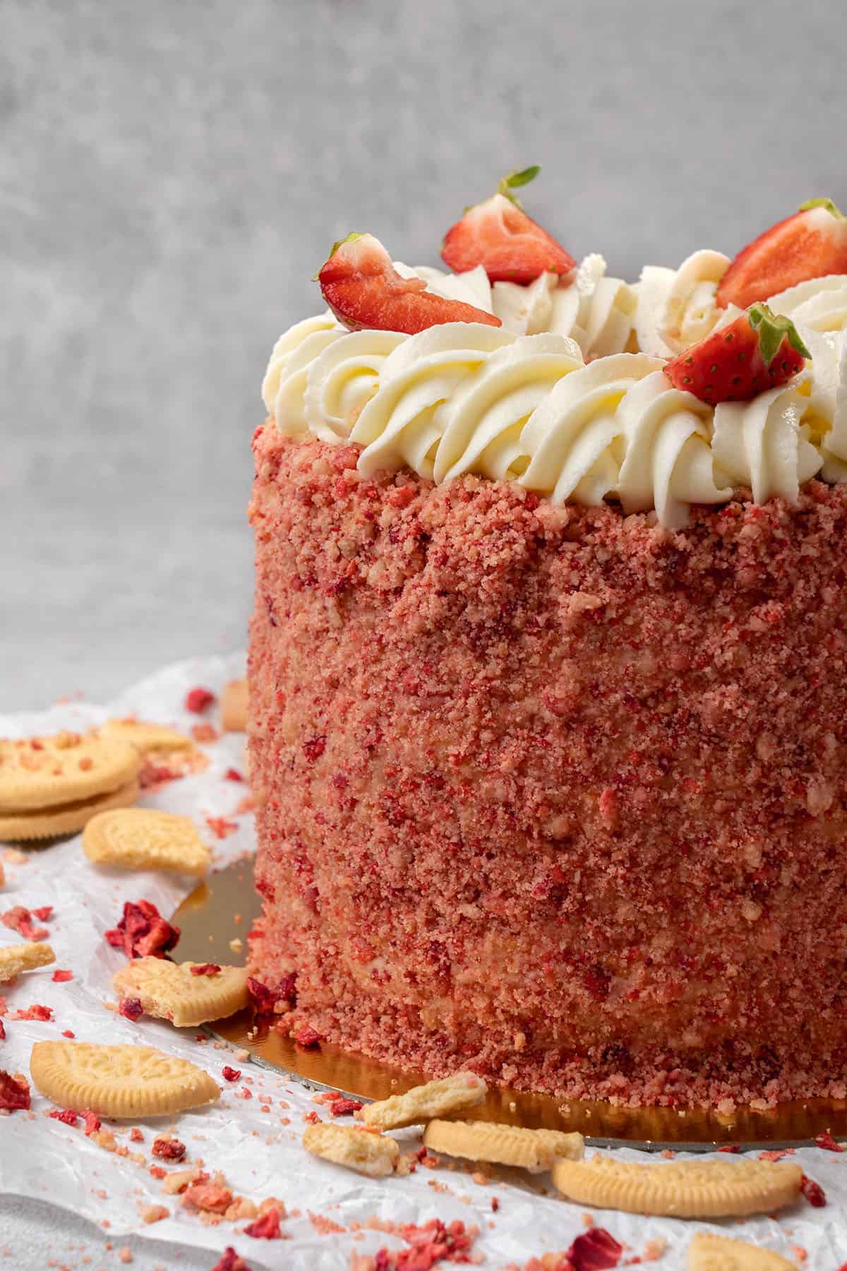 Strawberry crunch cake decorated with fresh strawberries.
