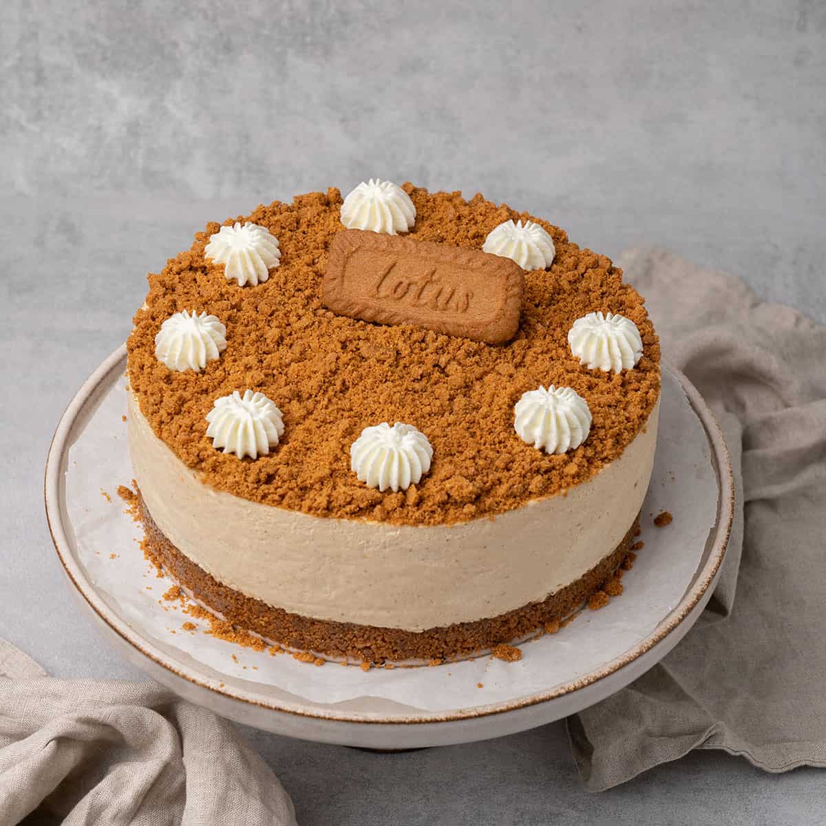 Biscoff cheesecake on a cake stand.