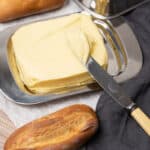 Homemade butter on a plate with bread.