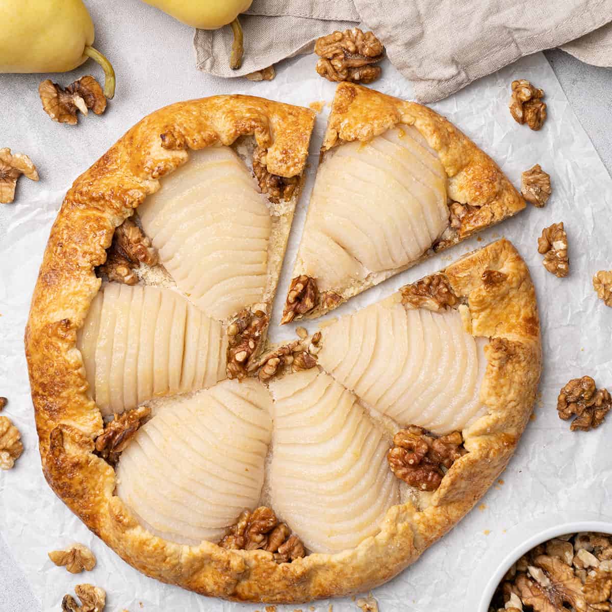 Pear galette decorated with walnuts.