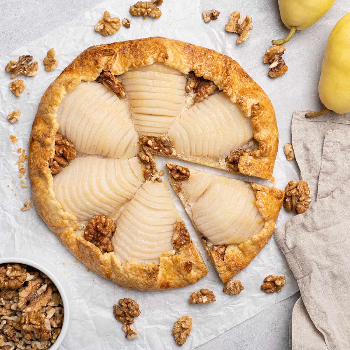 Pear galette decorated with walnuts.