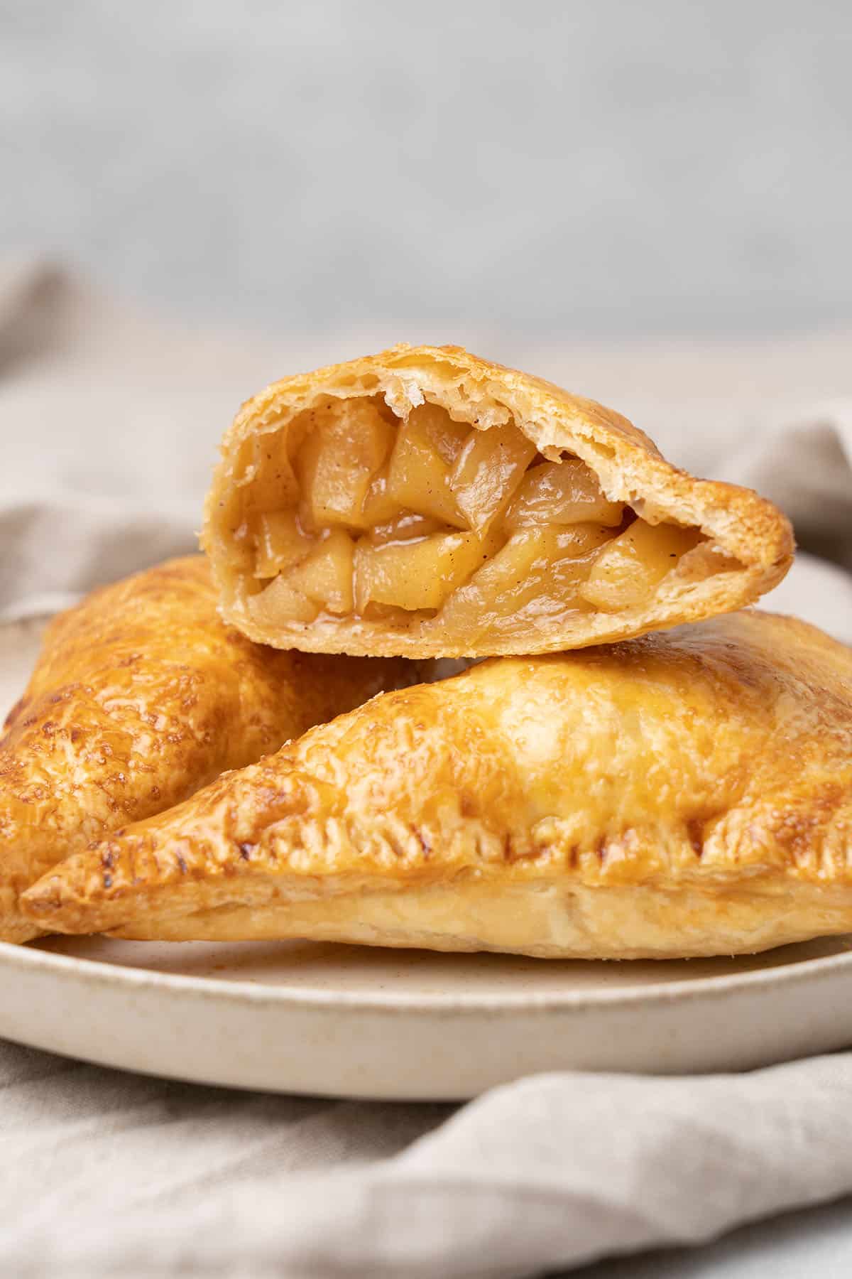 3 apple turnover on a a plate.
