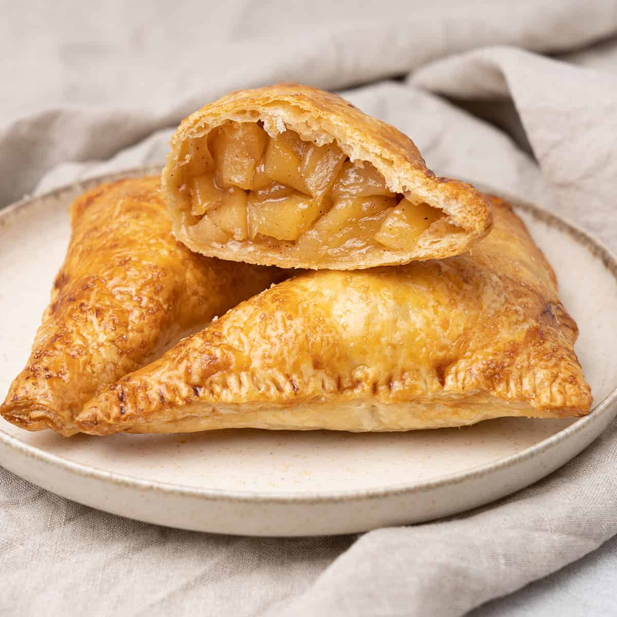 3 apple turnover on a a plate.