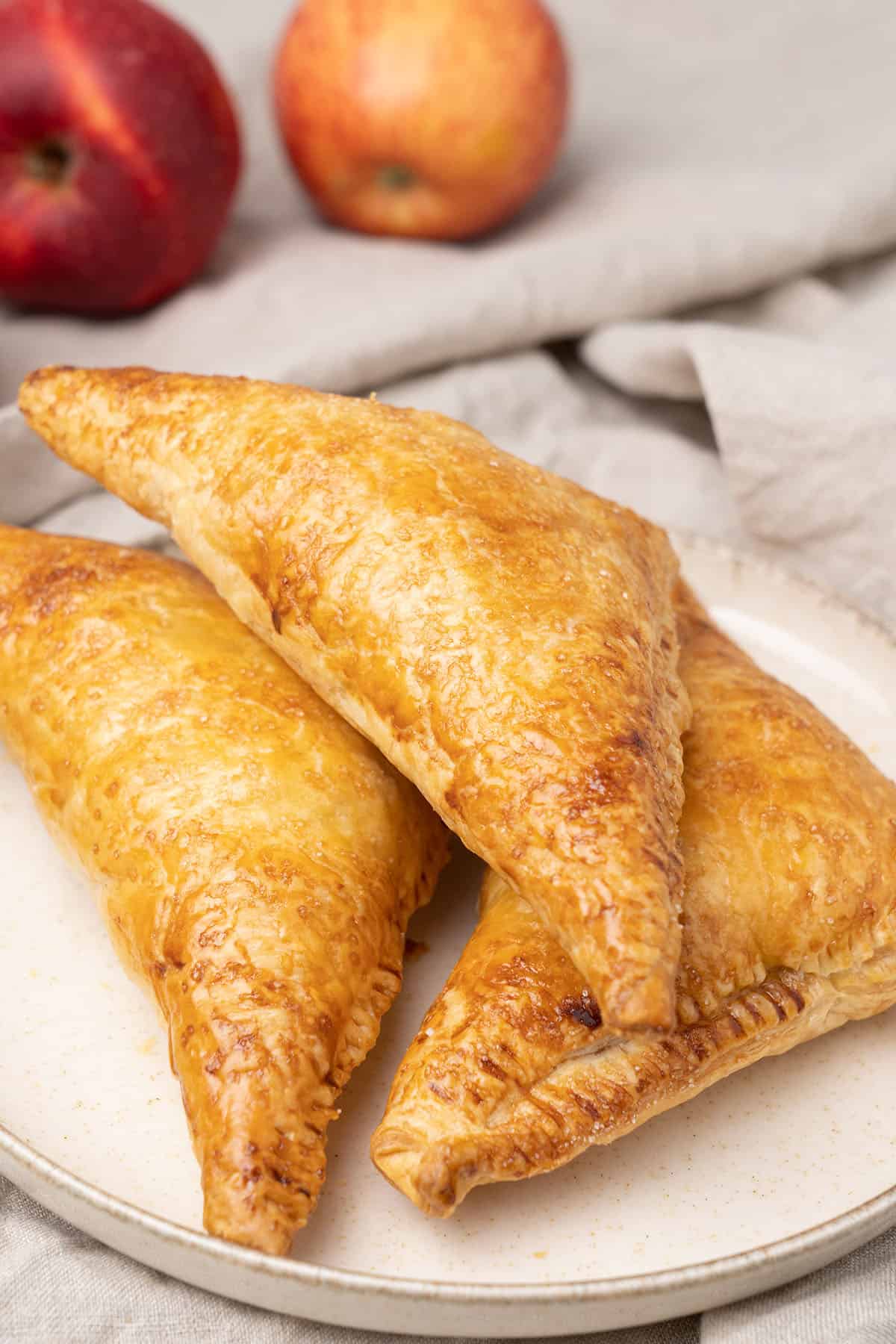 3 apple turnover on a a plate.