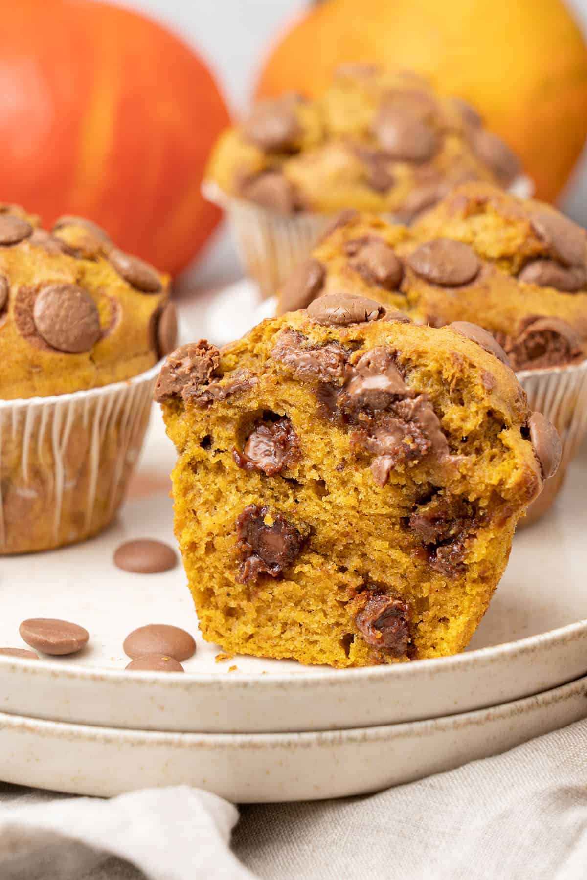 a half Pumpkin banana muffin on a plate.