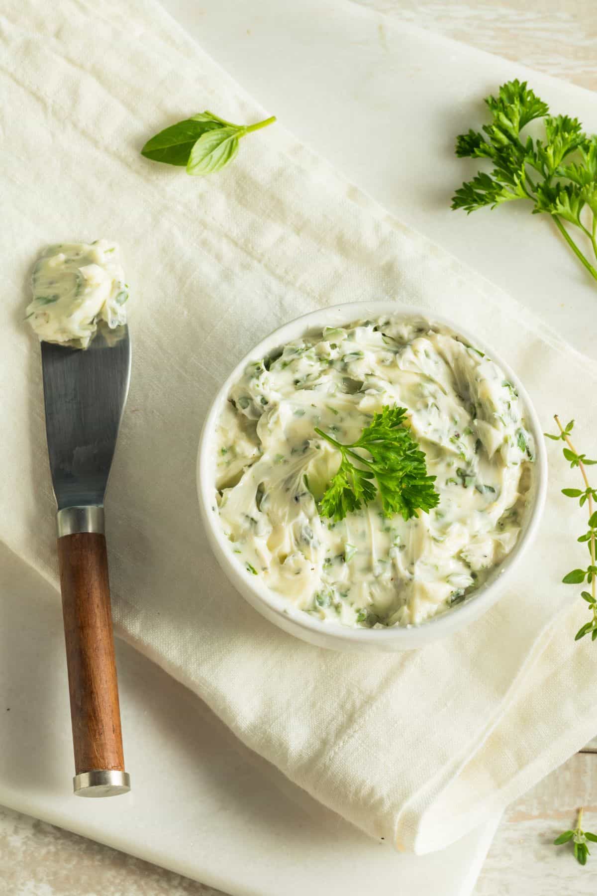 Butter mixed with parsley in a bowl.