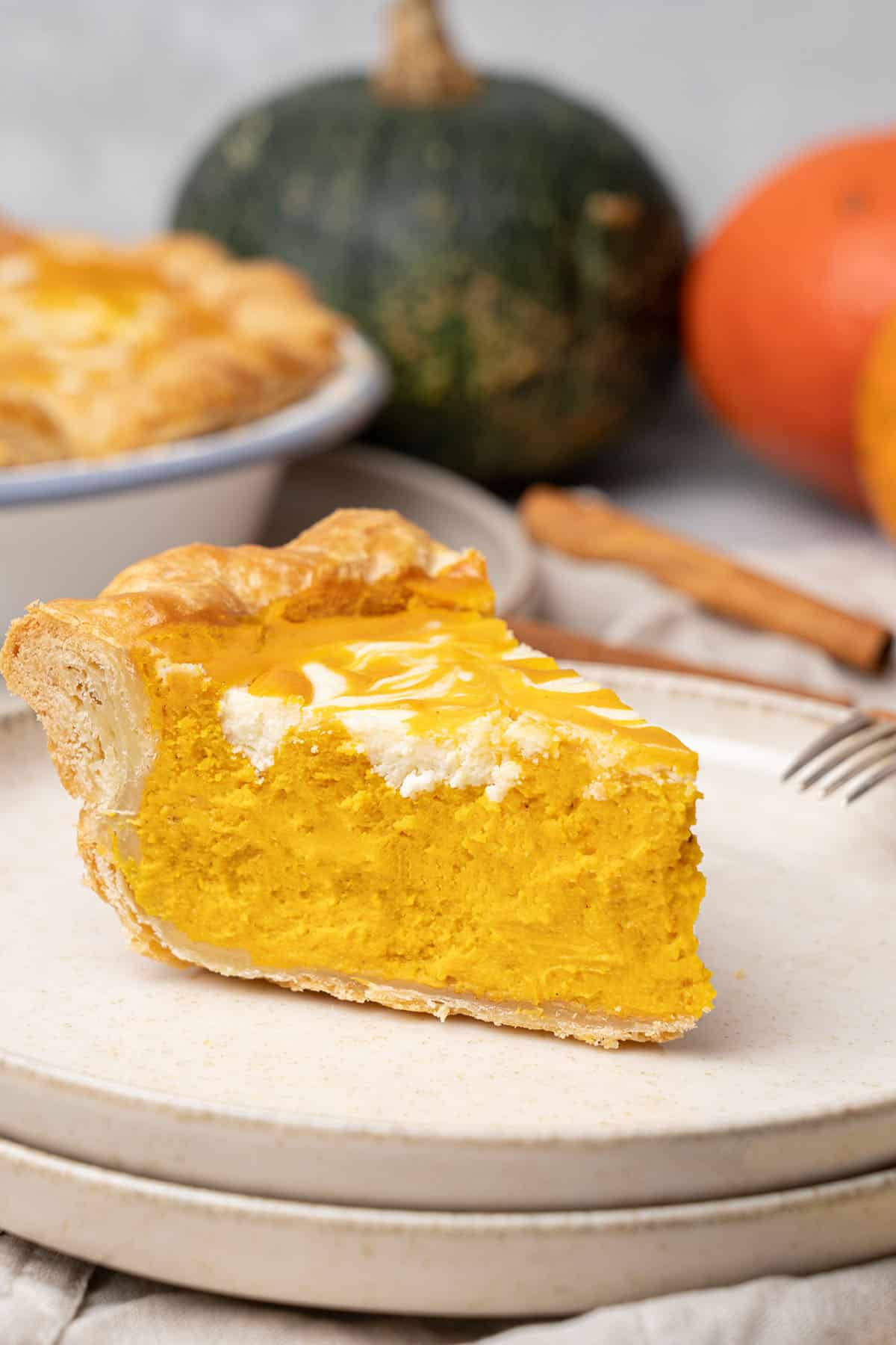 a slice of Pumpkin cream cheese pie on a plate.
