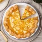 Pumpkin cream cheese pie on a plate.
