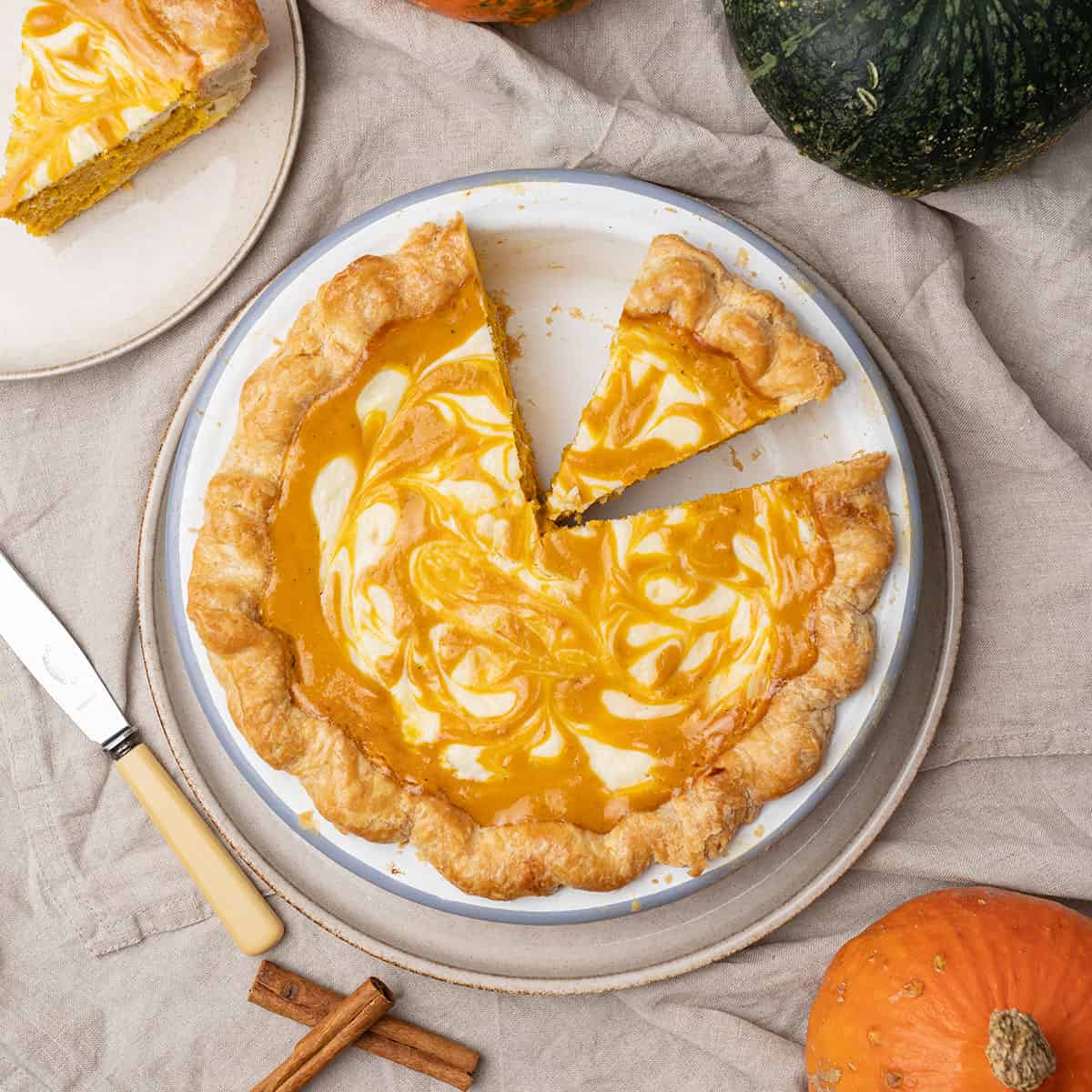 Pumpkin cream cheese pie on a plate.