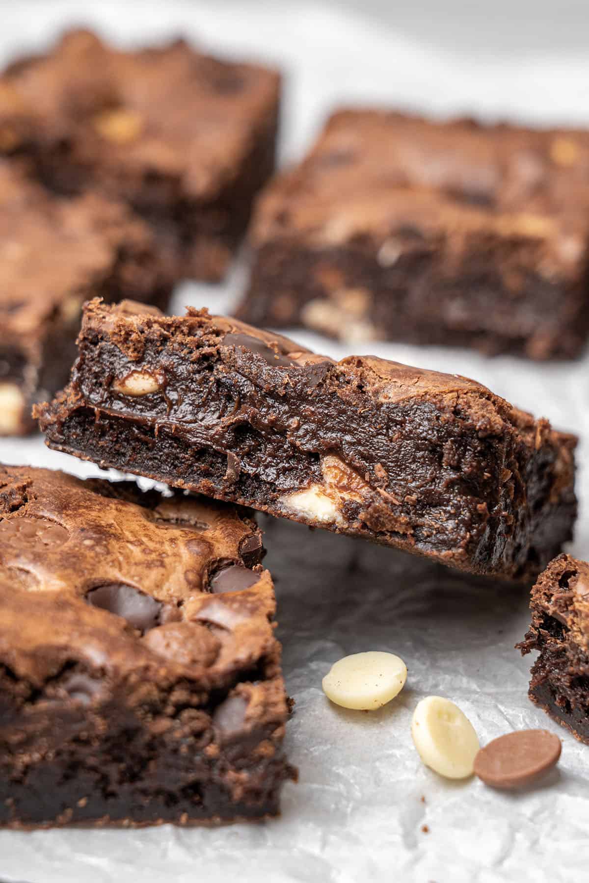 Triple chocolate brownies on a baking paper.