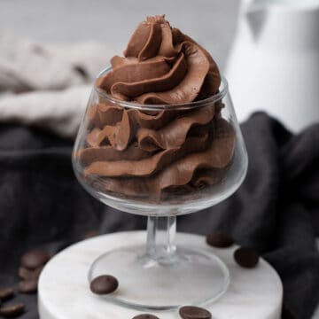 Whipped Chocolate Ganache Frosting in a glass.