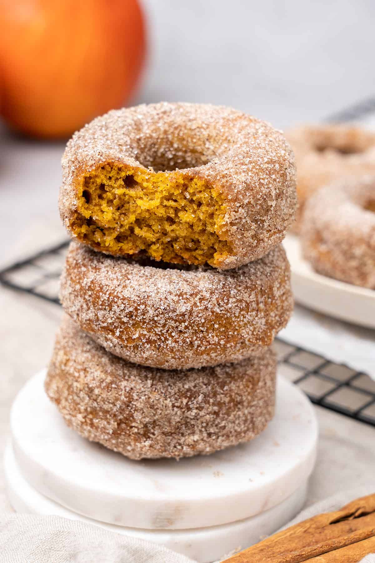 baked pumpkin spice donuts on a plate.