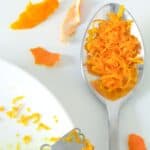orange zest in a spoon.