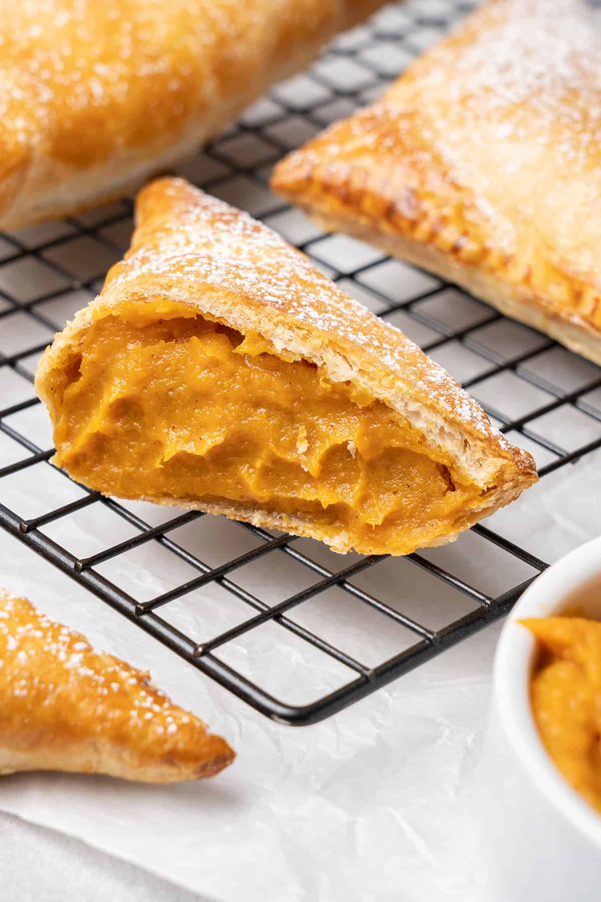 Pumpkin turnover on a cooling rack.