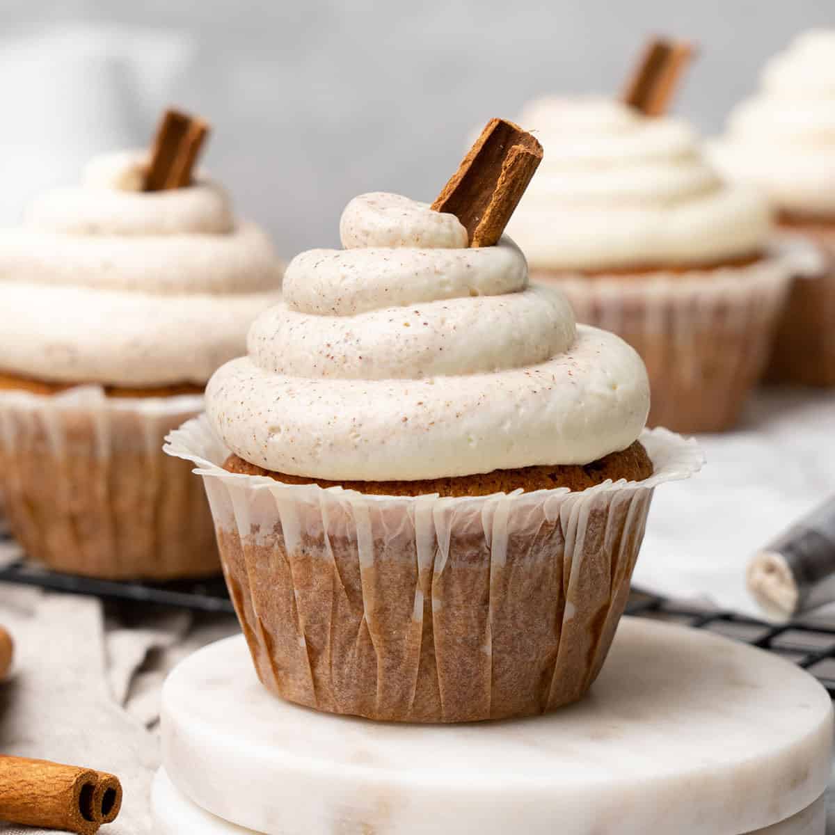 Cinnamon cupcakes on a cooling rack.