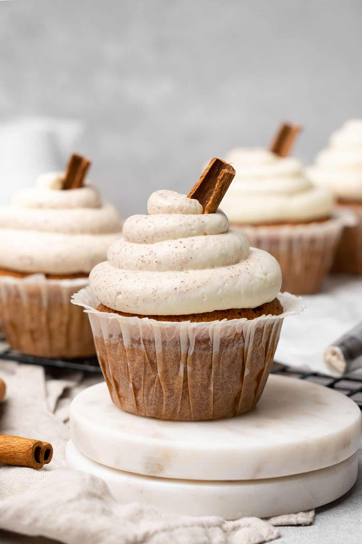 Cinnamon cupcakes on a cooling rack.