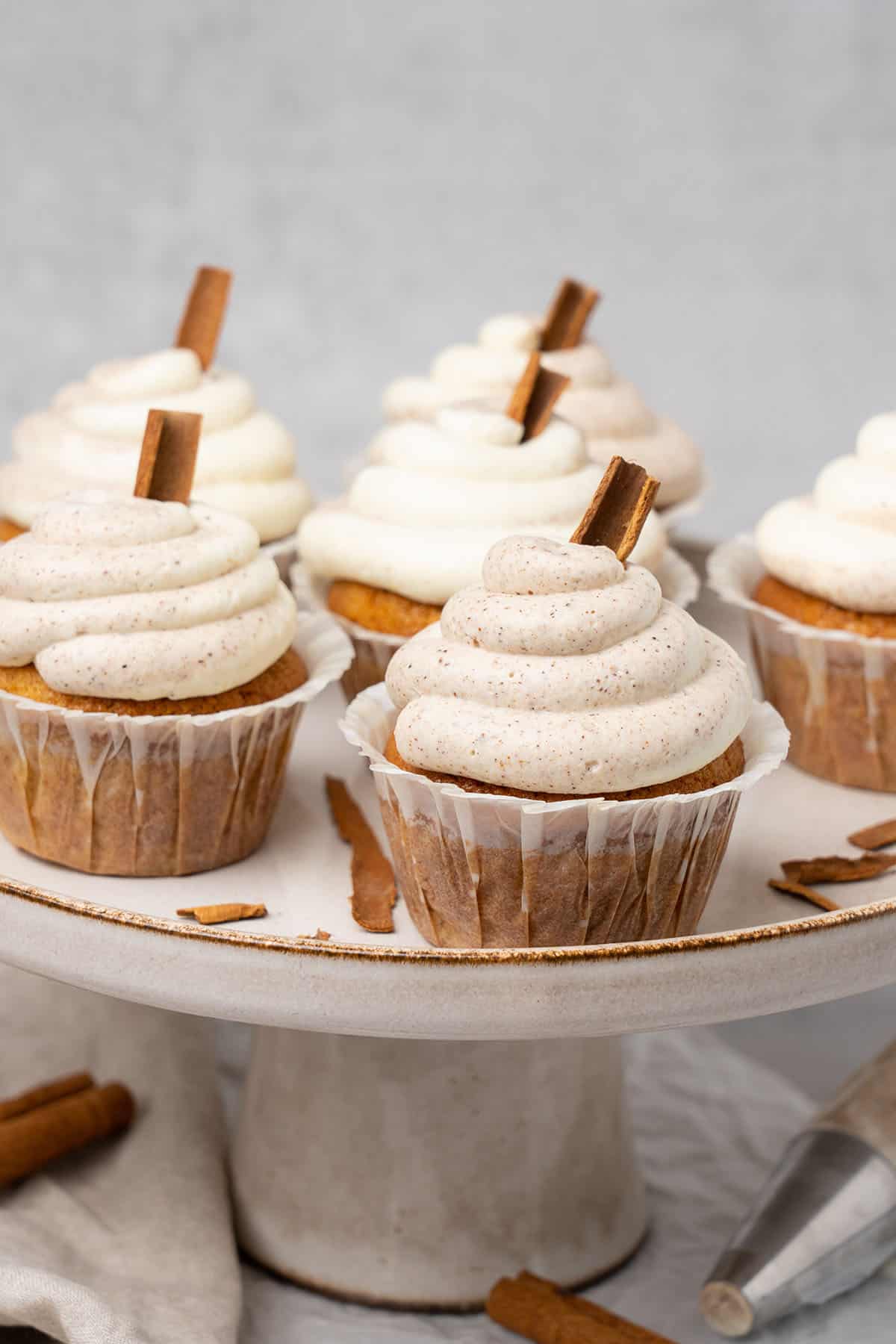 Cinnamon cupcakes on a cake stand.