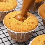 filling a cupcake with Biscoff spread.