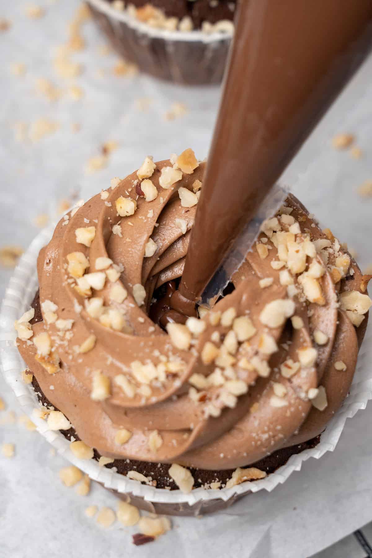 filling a cupcake with nutella.