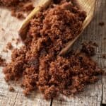 muscovado sugar in a wooden spoon.