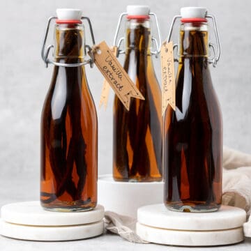 3 bottles with vanilla sticks in alcohol.