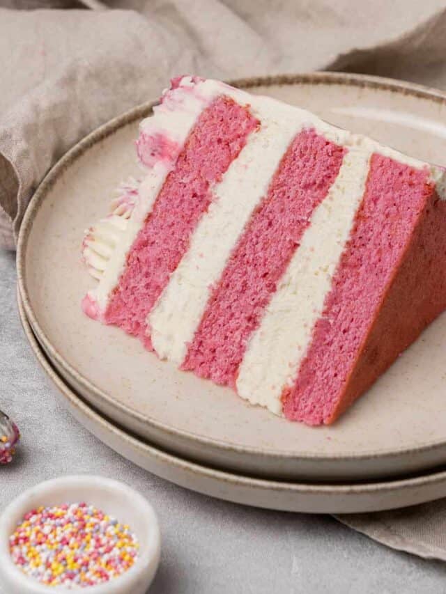 A slice of pink cake on a plate.