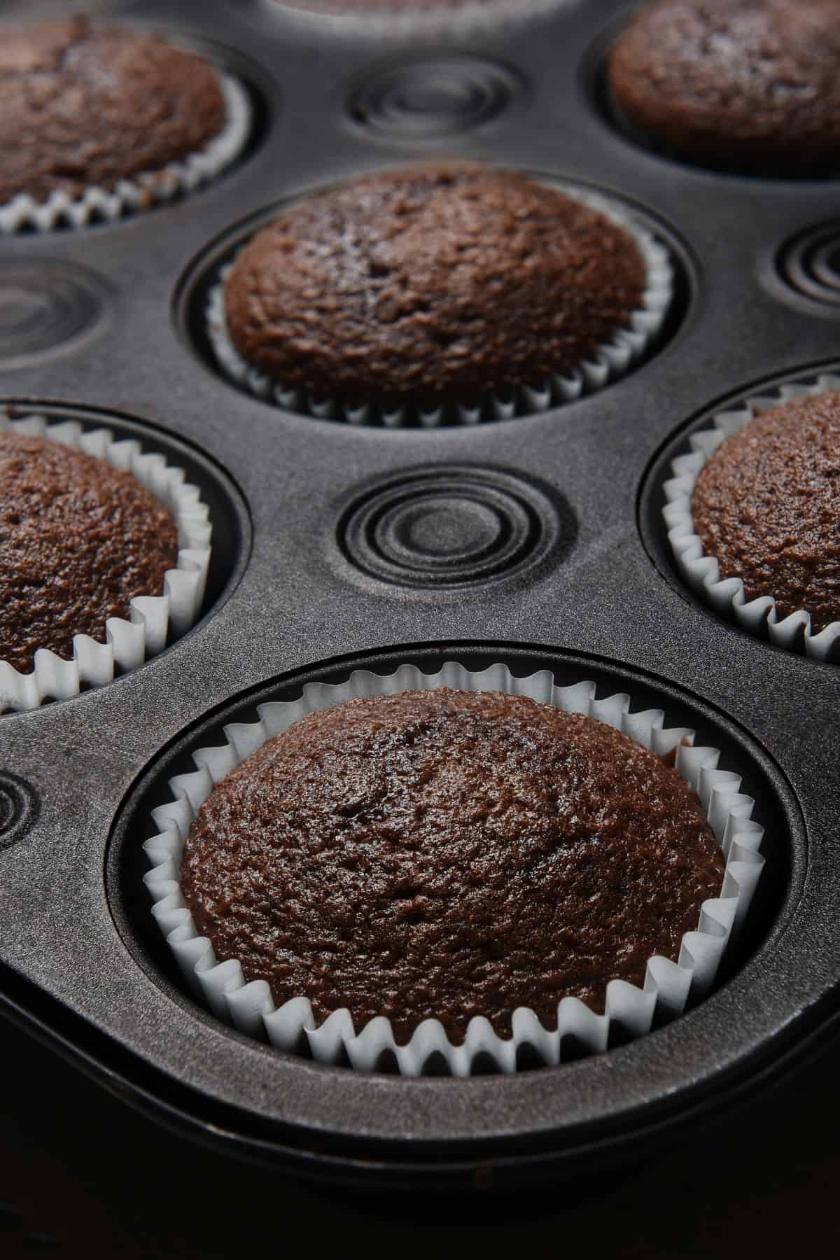 chocolate muffins in a muffin baking tin.