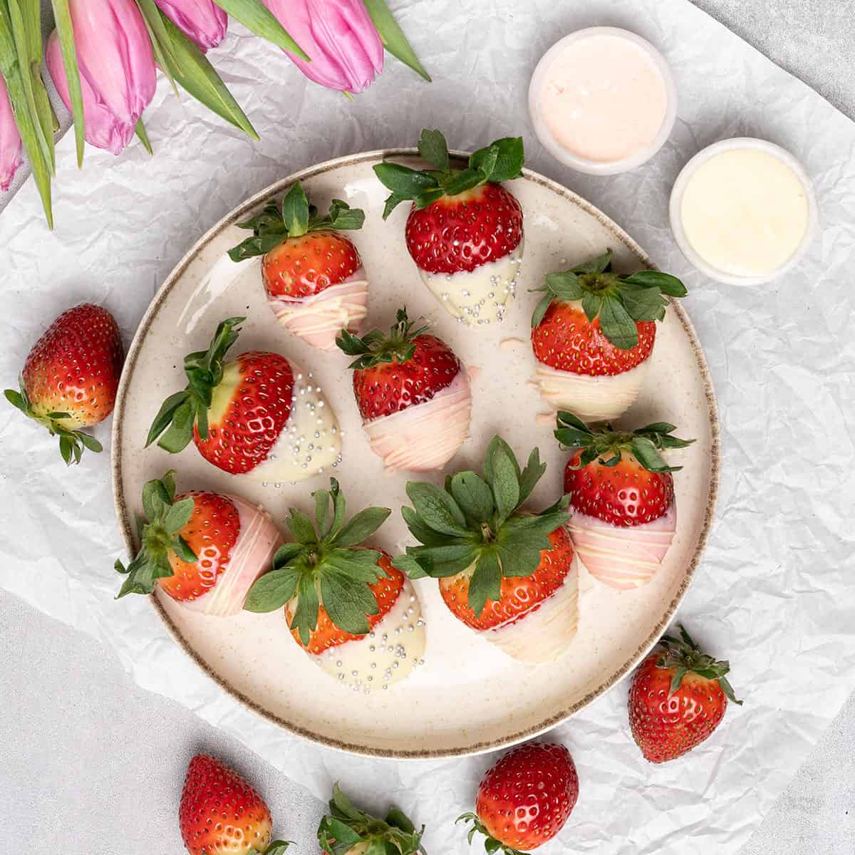 white chocolate covered strawberries on a plate.