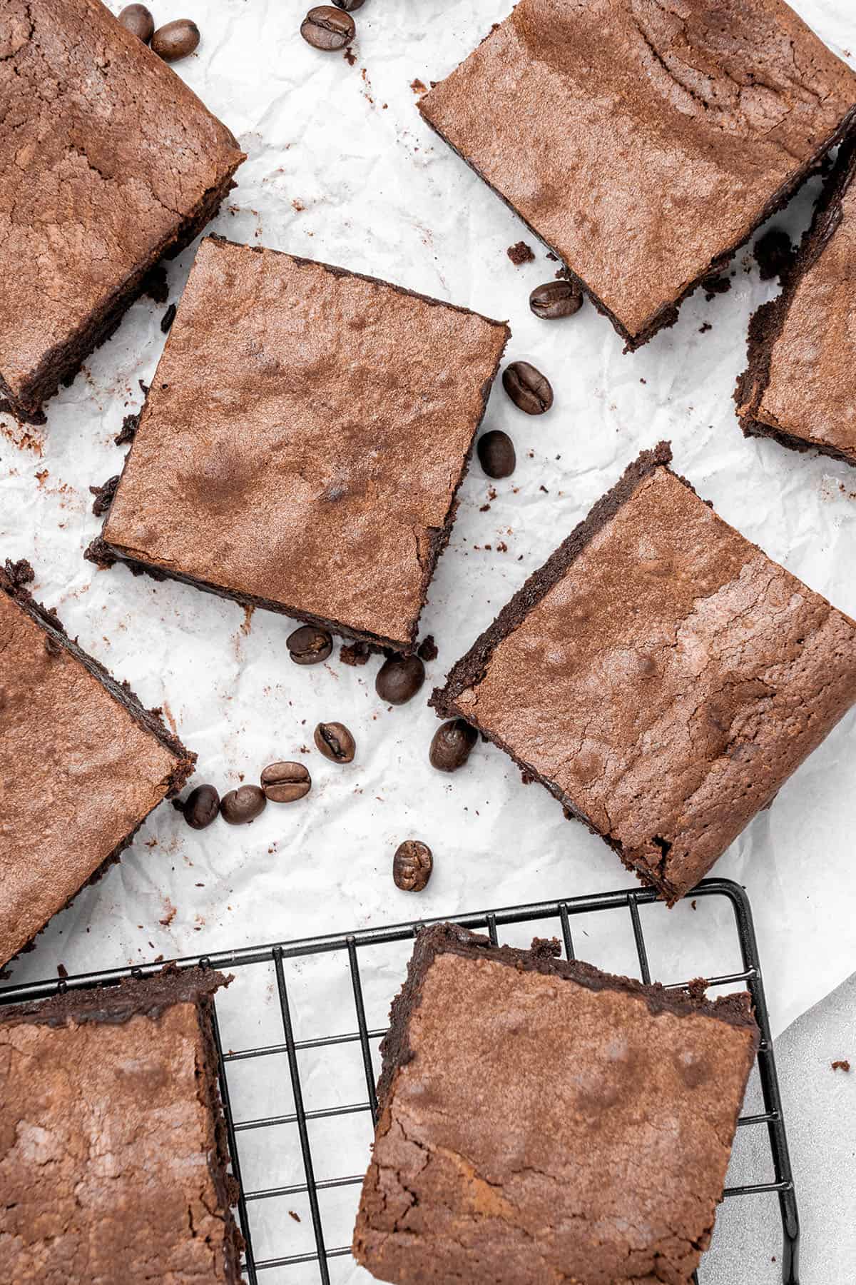 espresso brownies on baking paper and a cooling rack.