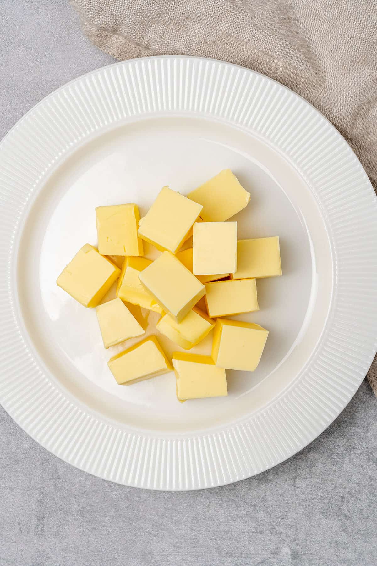 Butter cubes on a plate.