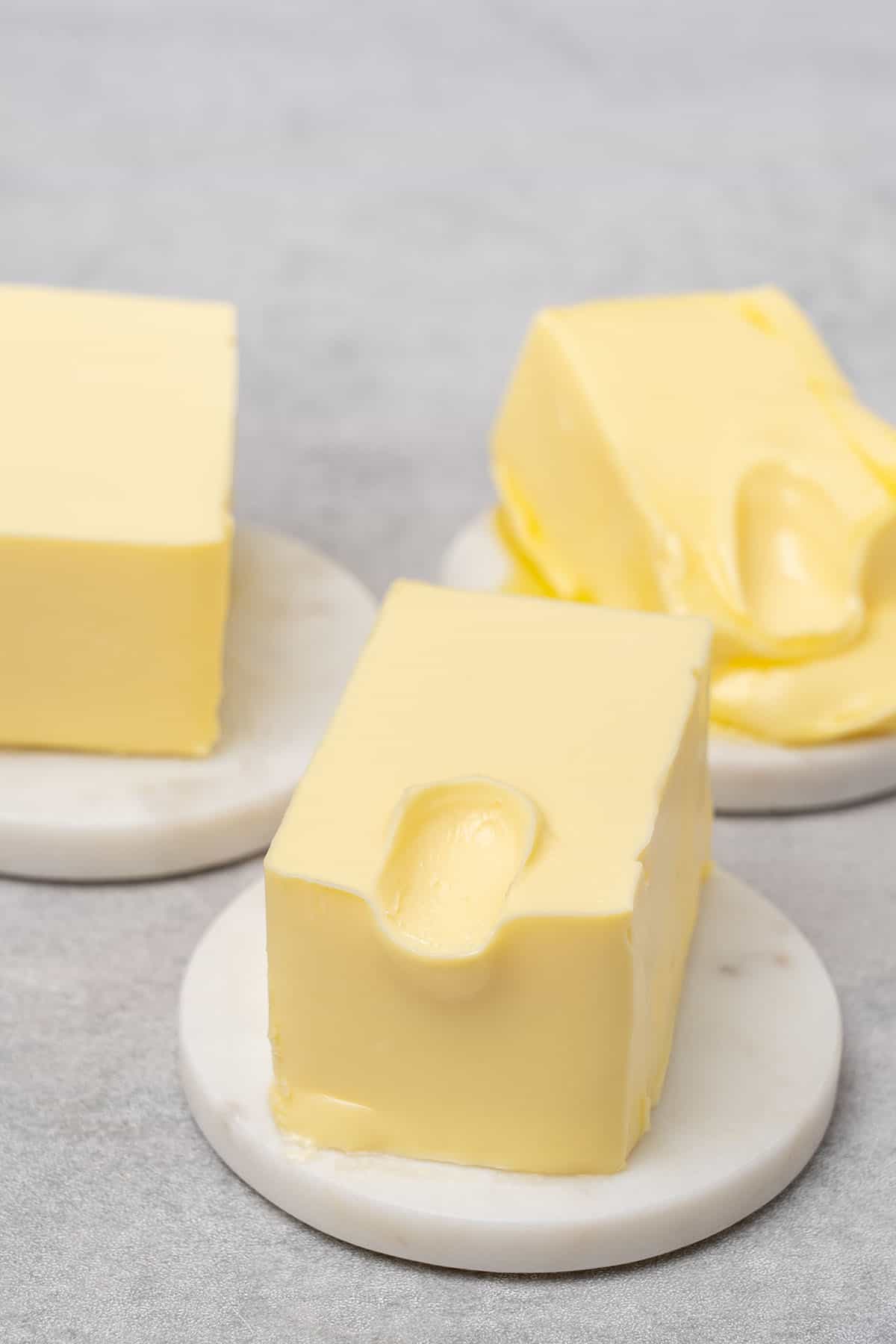 3 different types of softened butter on a plate.