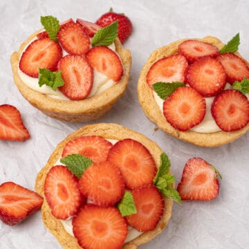 Mini strawberry pies on a baking paper.