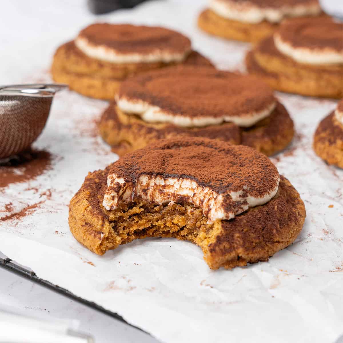 Tiramisu cookies on a cooling rack.